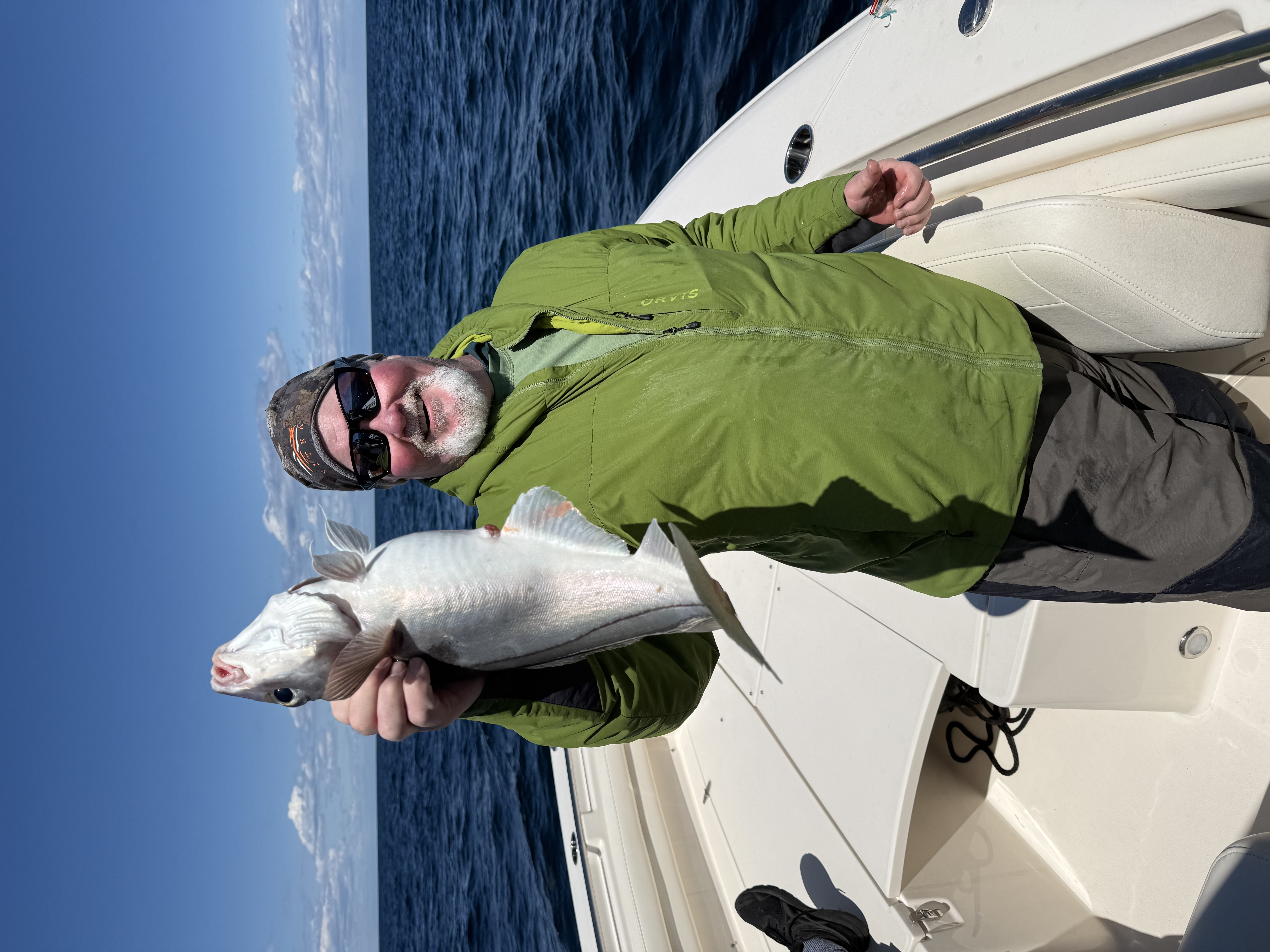 Angler holding a haddock caught on a Casco Bay fishing charter